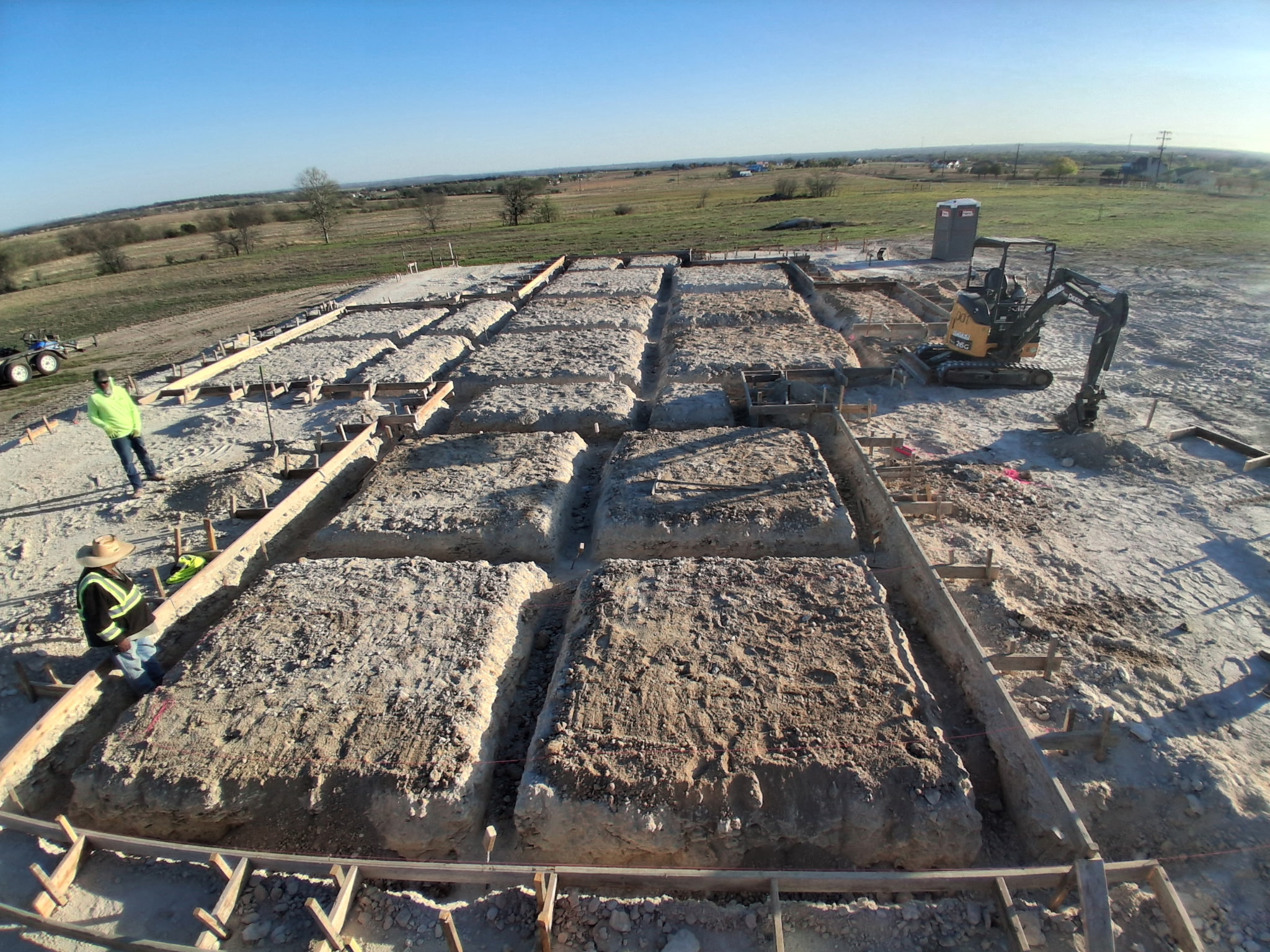 Aerial view of a large commercial concrete foundation excavation by APC