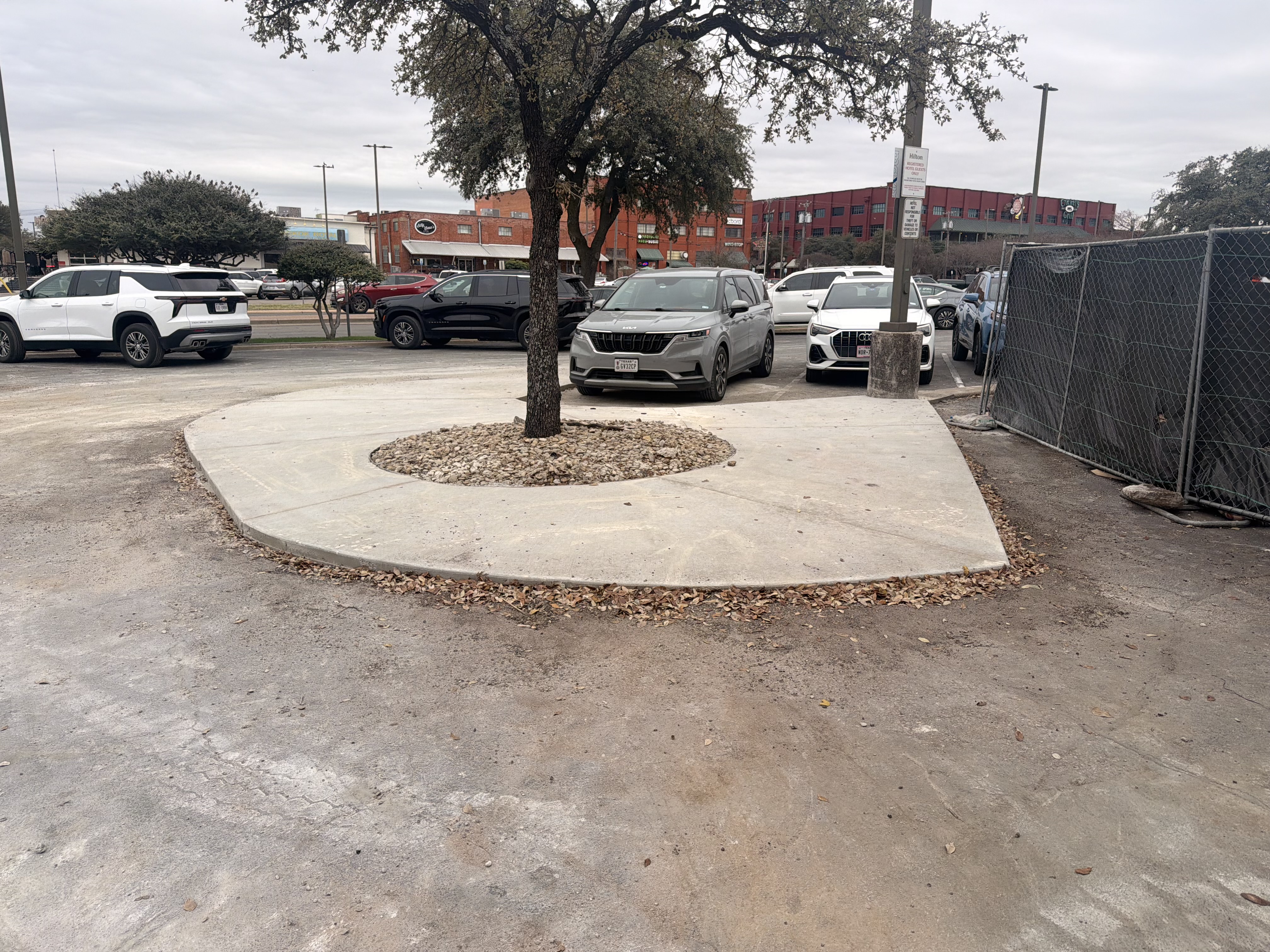 Finished concrete parking island in an urban commercial lot — APC Waco