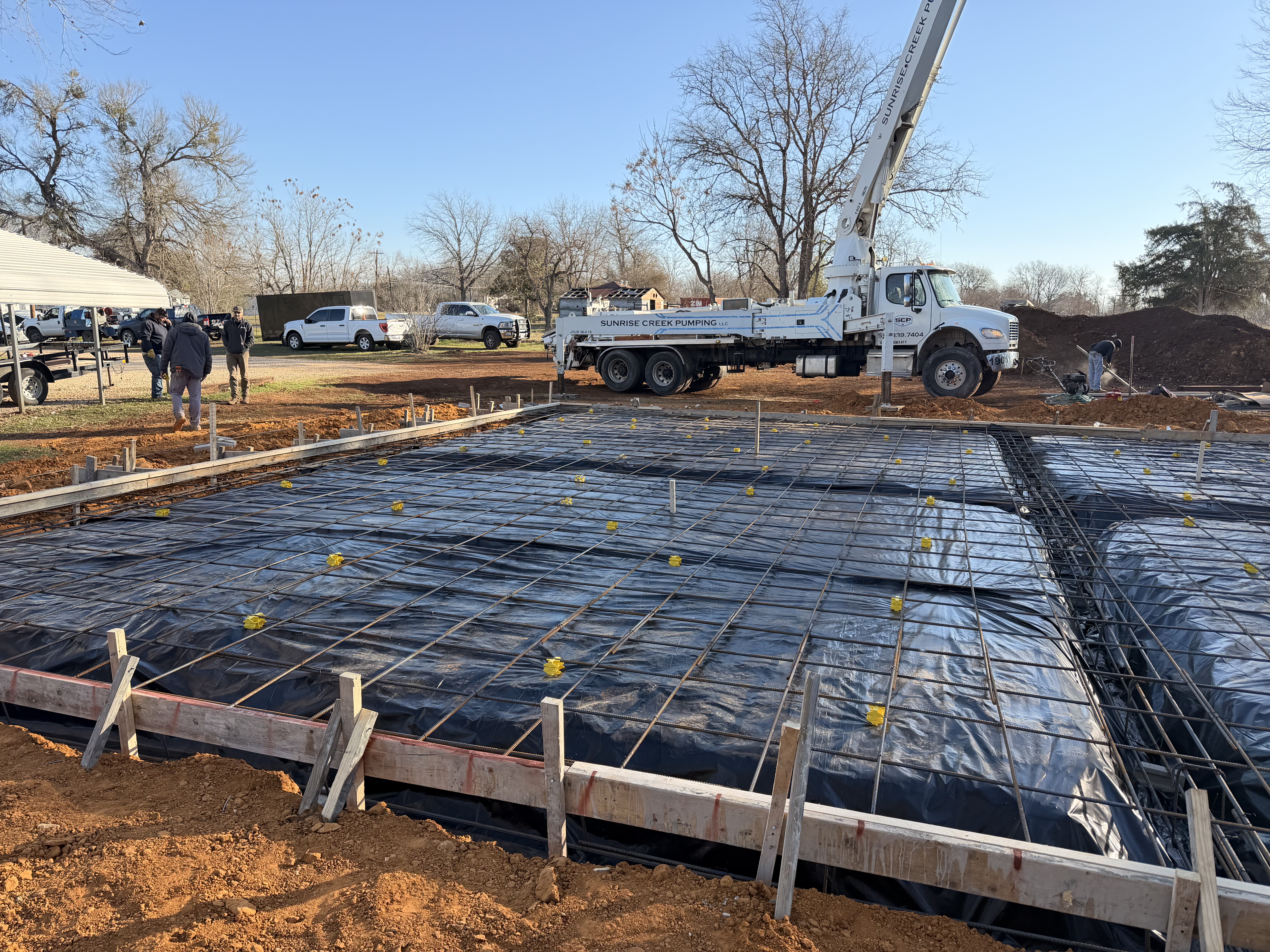 Residential foundation with rebar and concrete pump truck ready to pour — APC