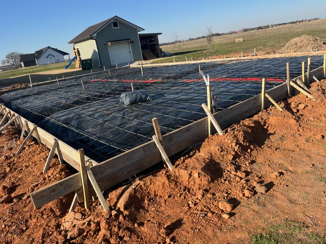 Residential home foundation with rebar and vapor barrier ready for pour — APC